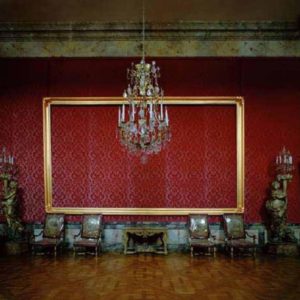 Empty Frame, Salle la cour a la fin du regne by Robert Polidori, baroque interior with red wallpaper, antique chairs and chandelier, with an empty gold frame on the wall