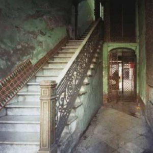 Paseo del Prado 105 by Robert Polidori, old staircase with cast iron railing and green marble walls