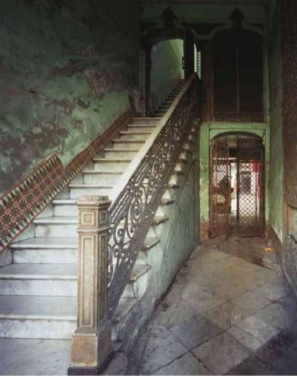 Paseo del Prado 105 by Robert Polidori, old staircase with cast iron railing and green marble walls