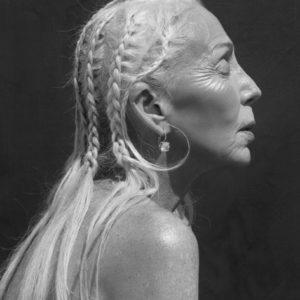 Colleen Heideman by Sylvie Blum, sideprofile portrait of the model wearing braids and diamond earrings