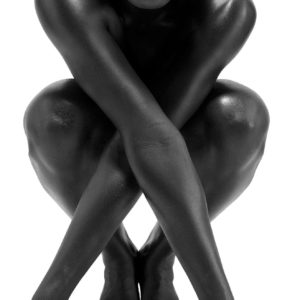 Crossed Arms by Sylvie Blum, black model crouching down to the camera, arms crossed in front of her body