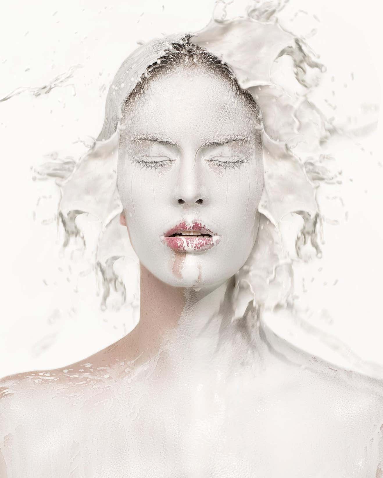 Milk One by Sylvie Blum, portrait of model with white painted face, white liquid splashing around her head