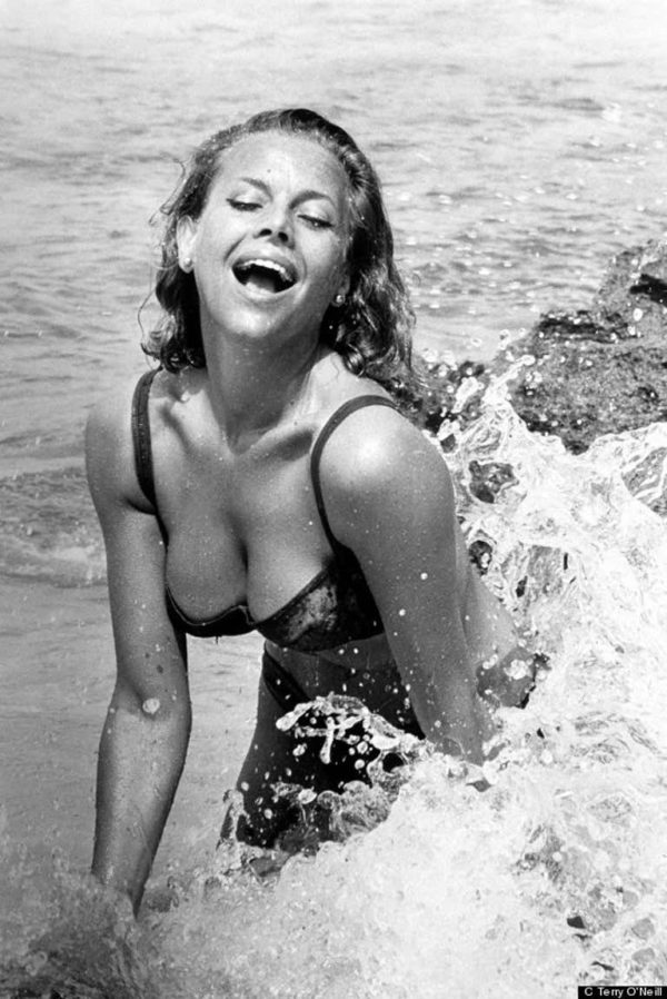 Honor Blackman by Terry O'Neill, the actress in a bikini splashing in the waves at the beach