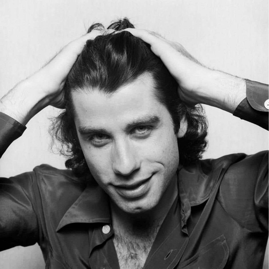 John Travolta by Terry O'Neill, black and white portrait of the actor with his hands in his hair