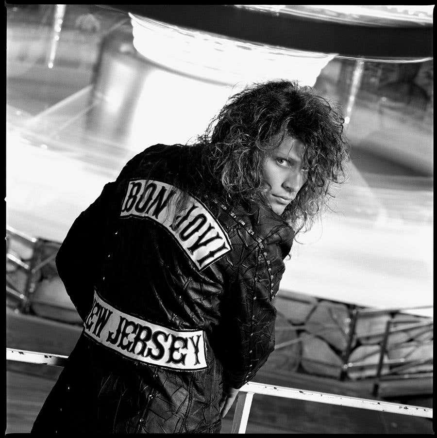 Jon Bon Jovi by Timothy White, portrait of the singer in a leather jacket and wild curly hair
