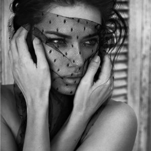 Adriana Lima by Vincent Peters, the model covering her face with a black veil with dots