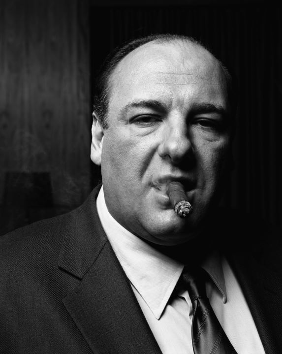 James Gandolfini by Timothy White, black and white portrait of the actor in a dark suit smoking a cigar