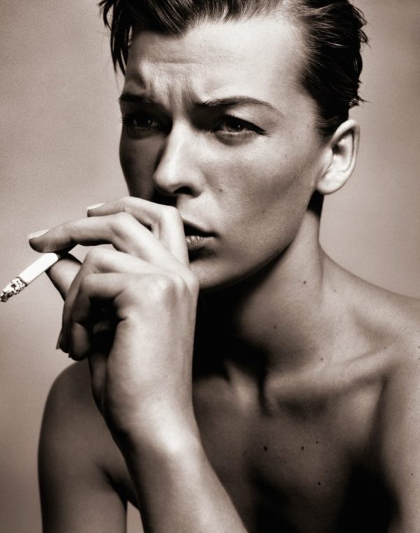 Mia Jovovich by Vincent Peters, the actress with short, slicked back hair smoking a cigarette