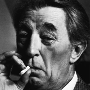 Robert Mitchum by Timothy White, black and white portrait of the actor in checkered suit, smoking a cigarette