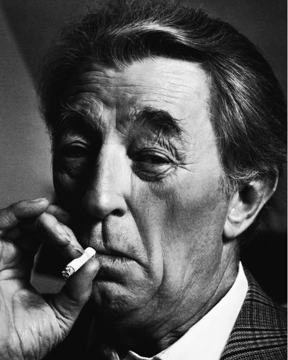 Robert Mitchum by Timothy White, black and white portrait of the actor in checkered suit, smoking a cigarette