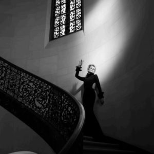 Sharon Stone 2016 by Timothy White, the actress in a black gown standing on stairs with cast iron railing
