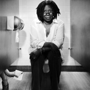 Whoopie Goldberg by Timothy White, the actress in white shirt and Converse, sitting on a public toilet
