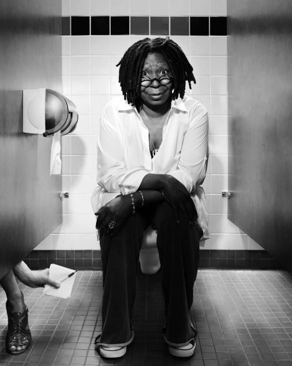 Whoopie Goldberg by Timothy White, the actress in white shirt and Converse, sitting on a public toilet