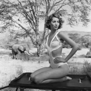 Christy Turlington Tanzania by Arthur Elgort, the model in a white bathing suit with an Elephant in the background