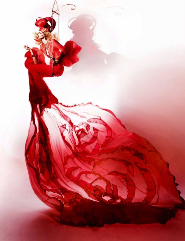 Floating Dress by Kristian Schuller, model in flowing red dress and headpiece on trapeze
