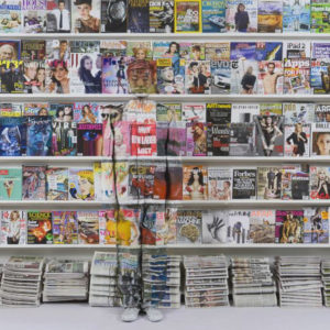 Hiding in New York Number 3 by Liu Bolin, storeshelfs with magazines