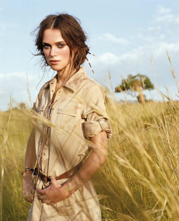 Keira Knigtley by Arthur Elgort, oprtrait of the actress in beige dress standing in high grass