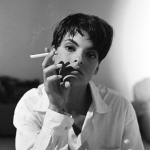 Linda Evangelista, New York City by Arthur Elgort, portrait of the model in a white shirt and short hair, smoking