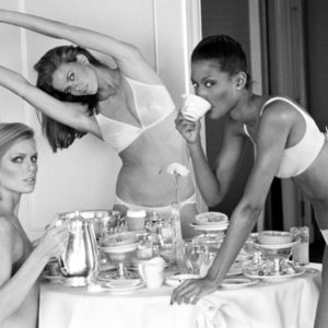 Patti Hansen, Lisa Taylor, and Beverly Johnson, San Francisco by Arthur Elgort, three models in underwear around a table drinking tea