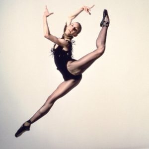 Wendy Whelan, NY city Ballet by Arthur Elgort, the ballerina in a black leotard and shoes jumping