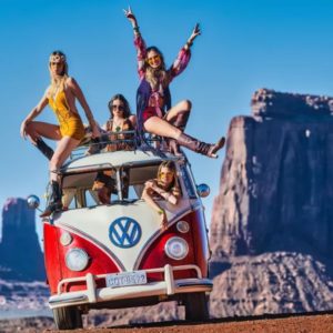 And the party never ends by  , red VW Bus with four girls in hippie clothing