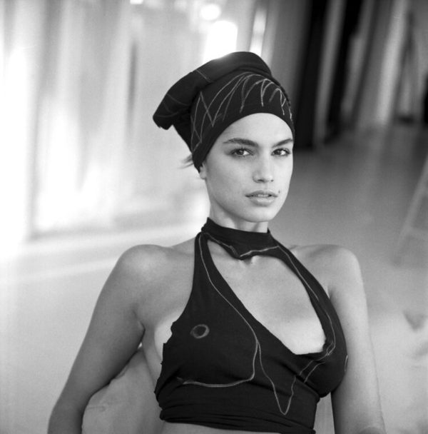 cindy crwaford by Arthur Elgort, black and white portrait of the model in black cutout top and headband