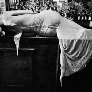 Elisa Jimenez, Ready to wear NY by Gérard Uféras, model in white dress lying on bar