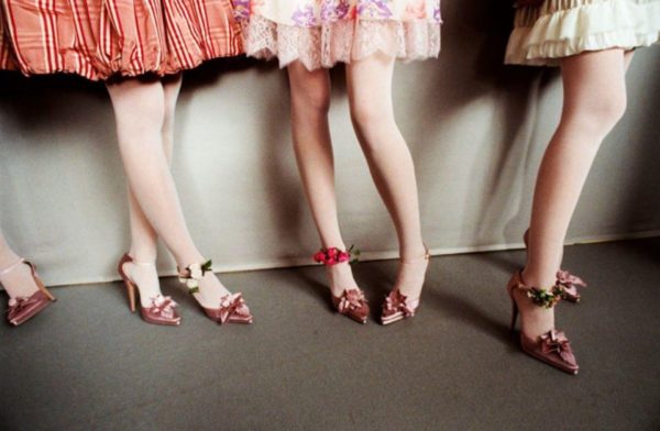 Pink Feet by Gérard Uféras, legs in pink tights and heels with flowers, whit frilly skirts