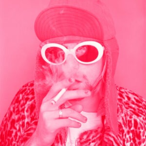 Kurt Cobain smoking pink by Jesse Frohman, portrait with cigarette sunglasses and hat