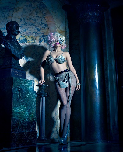 Lady Gaga by Markus Klinko, the singer in silver mask, bra and tights with hello kitty purse