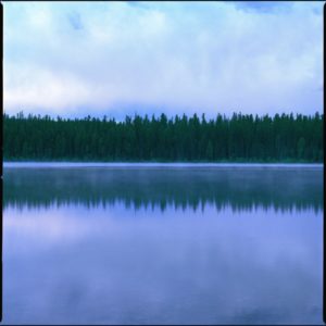 Montana 03 by Nigel Parry, Lake and trees reflecting in the water with cloudy sky