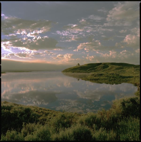 Yellowstone 18 by Nigel Parry, lake with green hills and cloudy sky