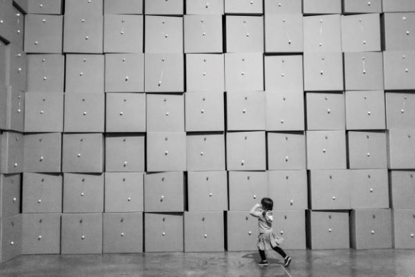 centquatre Paris by Gérard Uféras, child running in front of a paperbox wall