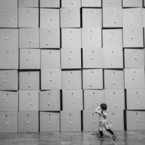centquatre Paris by Gérard Uféras, child running in front of a paperbox wall