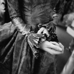 Gérard Uféras, Pierre Balmain Haute Couture, black-and-white fine art print of woman tucking at ruffled sleeve
