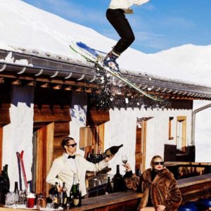 Club Paradiso by Tony Kelly, fine art photography, colour, shot in St. Moritz, waiter skiing off roof against wintry background