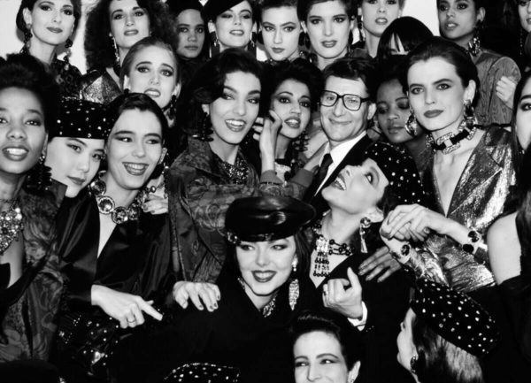 Yves Saint Laurent with Models by Roxanne Lowit, black-and-white fine art photography showing the designer surrounded by models