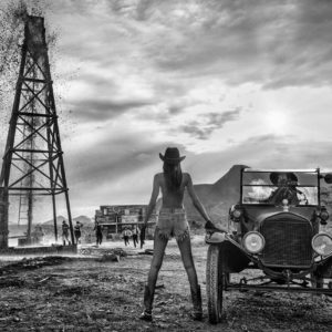 There Will Be Oil by David Yarrow, black-and-white fine art photography showing model in front of Western oil scenery