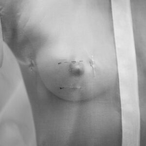 Dior Haute Couture, 30 avenue Montaigne by Gérard Uféras - closeup of a Models Nipple through a transparent Shirt