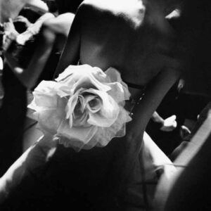 Gianfranco Ferré backstage by Gérard Uféras - black and white image of Model in a dress with huge white fabric rose