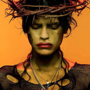Omahyra by Albert Watson - Portrait with dirty face, crown of thorns and orange background