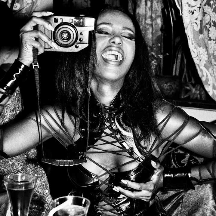 Iman by Roxanne Lowit, Model holding a camera, black-and-white fine art photography