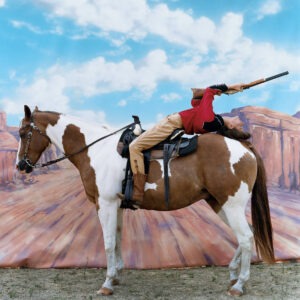 Arthur Elgort: Carmen Kass Annie get your gun for Vogue US 2002, bending backwards on a paint horse