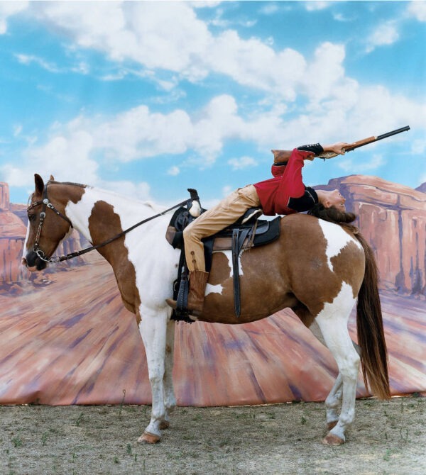 Arthur Elgort: Carmen Kass Annie get your gun for Vogue US 2002, bending backwards on a paint horse