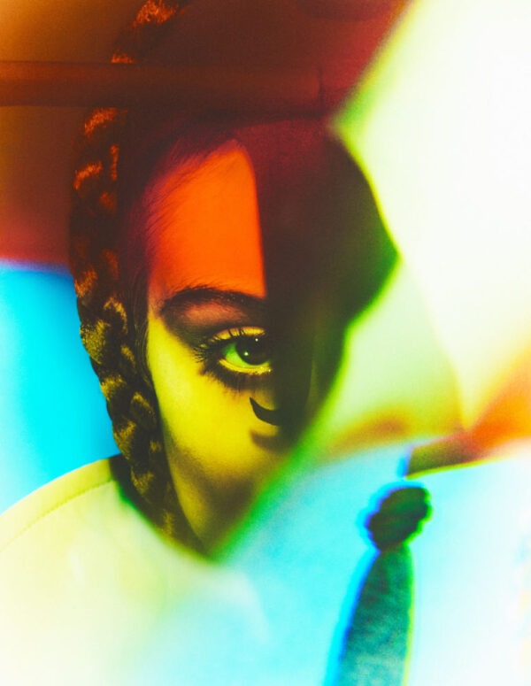 Tush by Kristian Schuller, half face portrait in bright colored light