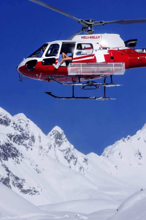 Tony Kelly, Heli Kelly! red and white helicopter above snowy mountains