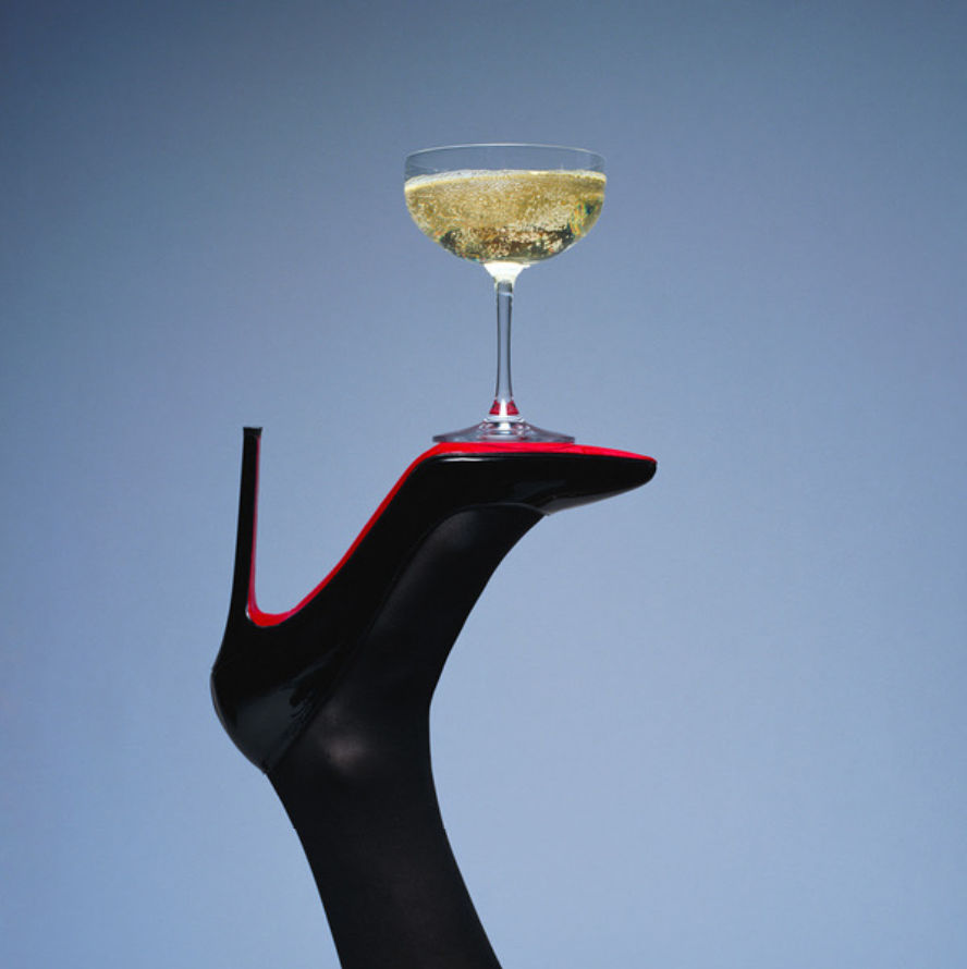 Shields, Champagne High Heel, champagne glass balancing on a louboutin heel