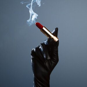 Shields, Lipstick Cigarette 2022, gloved hand holding a smoking Lipstick