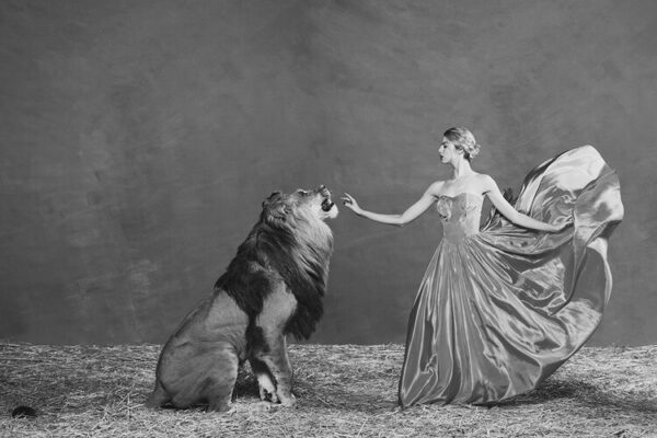 Shields, The Lion Queen, Model in dress touching a lion