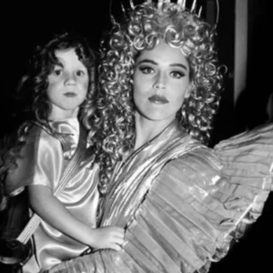 Sharon Stone Angel by Roxanne lowit, the actress in an angel costume holding a child